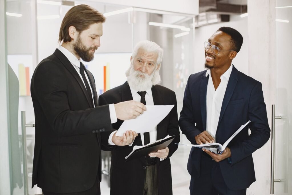 Three people reviewing documents together